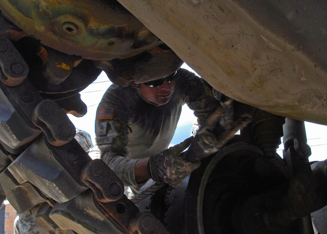 U.S. Army Staff Sgt. Kevin Harvey attaches a tow cable to an M60 Patton Tank during a training exercise at the National Guard Armory in Bluffton, Ind., June 30, 2009. Harvey is a mechanic assigned to the 2025th Transportation Company.
