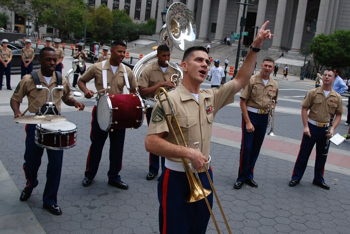 Staff Sgt. Kem Ebo, Quntico Va., Marine Corps Band, Dixieland band leader, sings and plays with the rest of the six-Marine band in Foley Square, New York City, July 13.  These Marines are part of one of the oldest ensembles in the Marine Corps. (Official Marine Corps photo by Sgt. Randall A. Clinton)