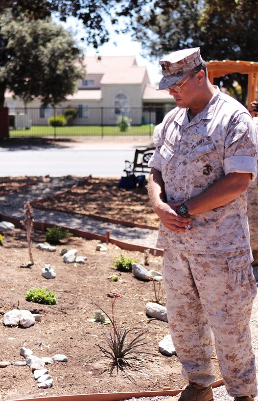 Lt. Cmdr. Marc G. Diconti, chaplain, Marine Corps Base Camp Pendleton, bows his head in prayer during the unveiling ceremony of the new prayer garden located in front of the Blinder Memorial Chapel, July 13.