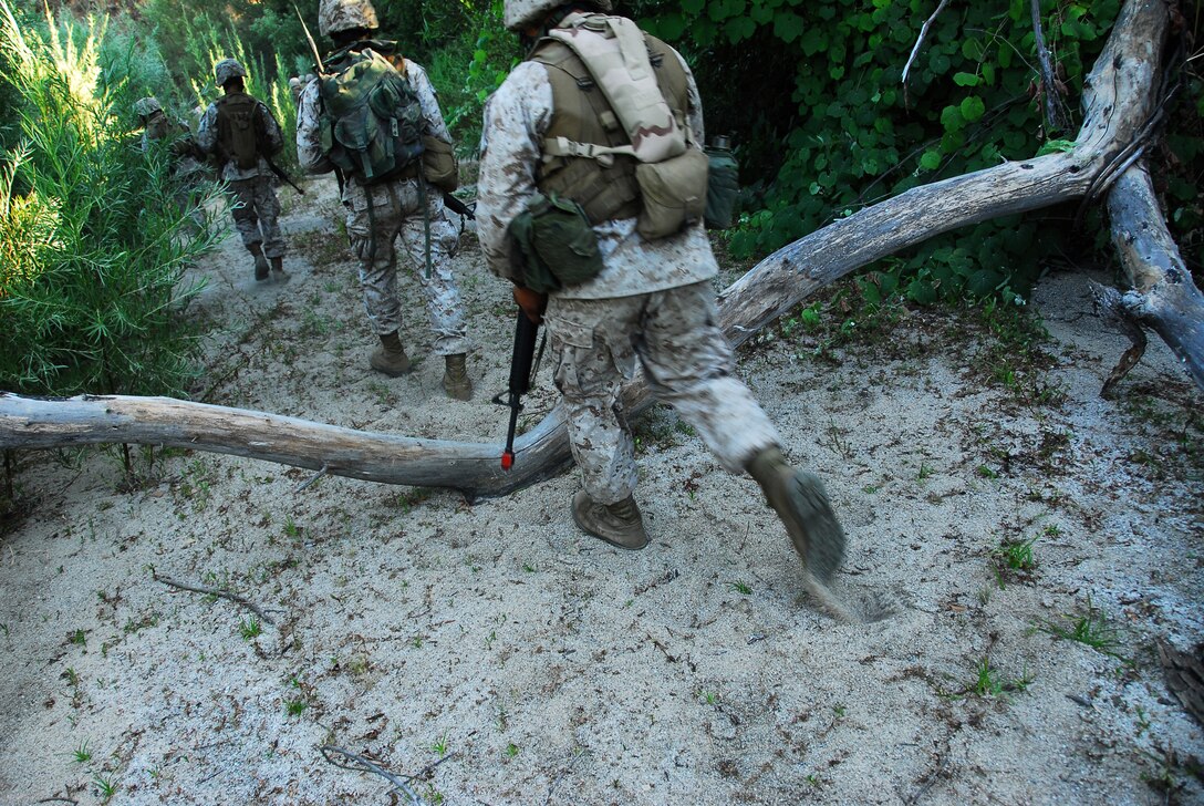 Yuma Headquarters and Headquarters Squadron Marines patrol in Camp Pendleton, Calif., during the Enhanced Combat Skills course July 13, 2009. Marines attended the training in order to hone skills they learned through boot camp and Marine Combat Training as well as learn new techniques applicable to Iraq or Afghanistan.