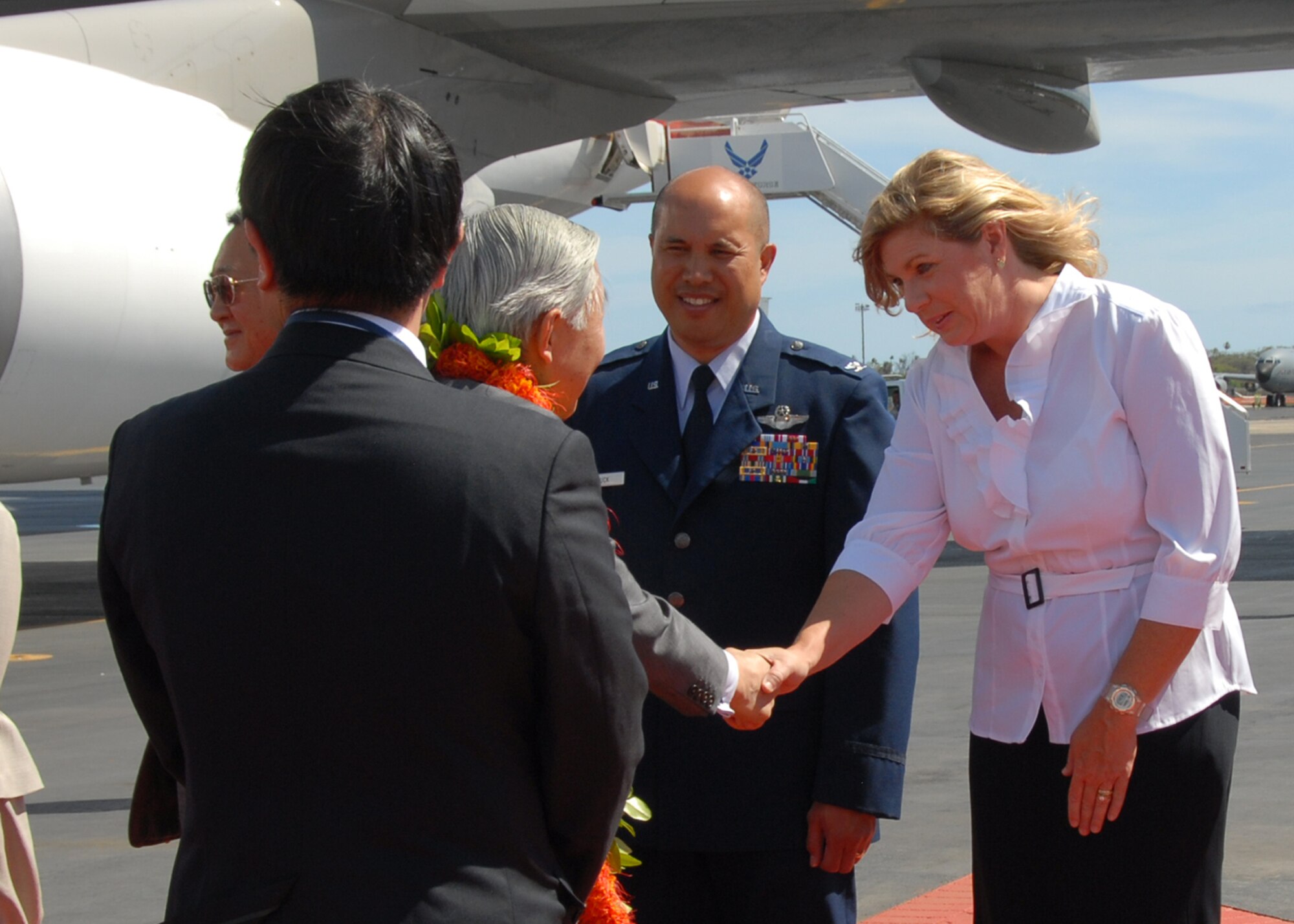Emperor Akihito, Emperor of Japan, greets Col. Giovanni Tuck, 15th Airlift Wing commander, and his wife Susie, during the Emperor's arrival at Hickam Air Force Base, Hawaii, July 14. Navy Adm. Timothy Keating, U.S. Pacific Command commander, and Hawaii Gov. Linda Lingle were also present to greet the Emperor during his visit to Hawaii. Emperor Akihito and Empress Michiko are also scheduled to lay a wreath at the National Memorial Cemetery of the Pacific during their visit. (U.S. Air Force photo/Staff Sgt. LuCelia Ball)
