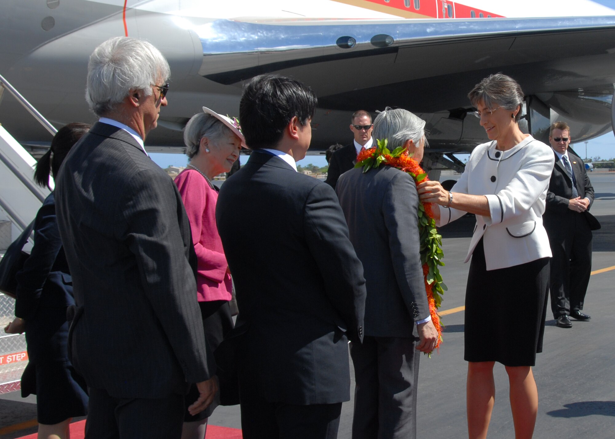 Hawaii Gov. Linda Lingle presents Emperor Akihito with a flower lei during his arrival at Hickam Air Force Base, Hawaii, July 14. Also in place to greet them were Navy Adm. Timothy Keating, U.S. Pacific Command commander, and Col. Giovanni Tuck, 15th Airlift Wing commander. Emperor Akihito and Empress Michiko are also scheduled to lay a wreath at the National Memorial Cemetery of the Pacific during their visit. (U.S. Air Force photo/Staff Sgt. LuCelia Ball)