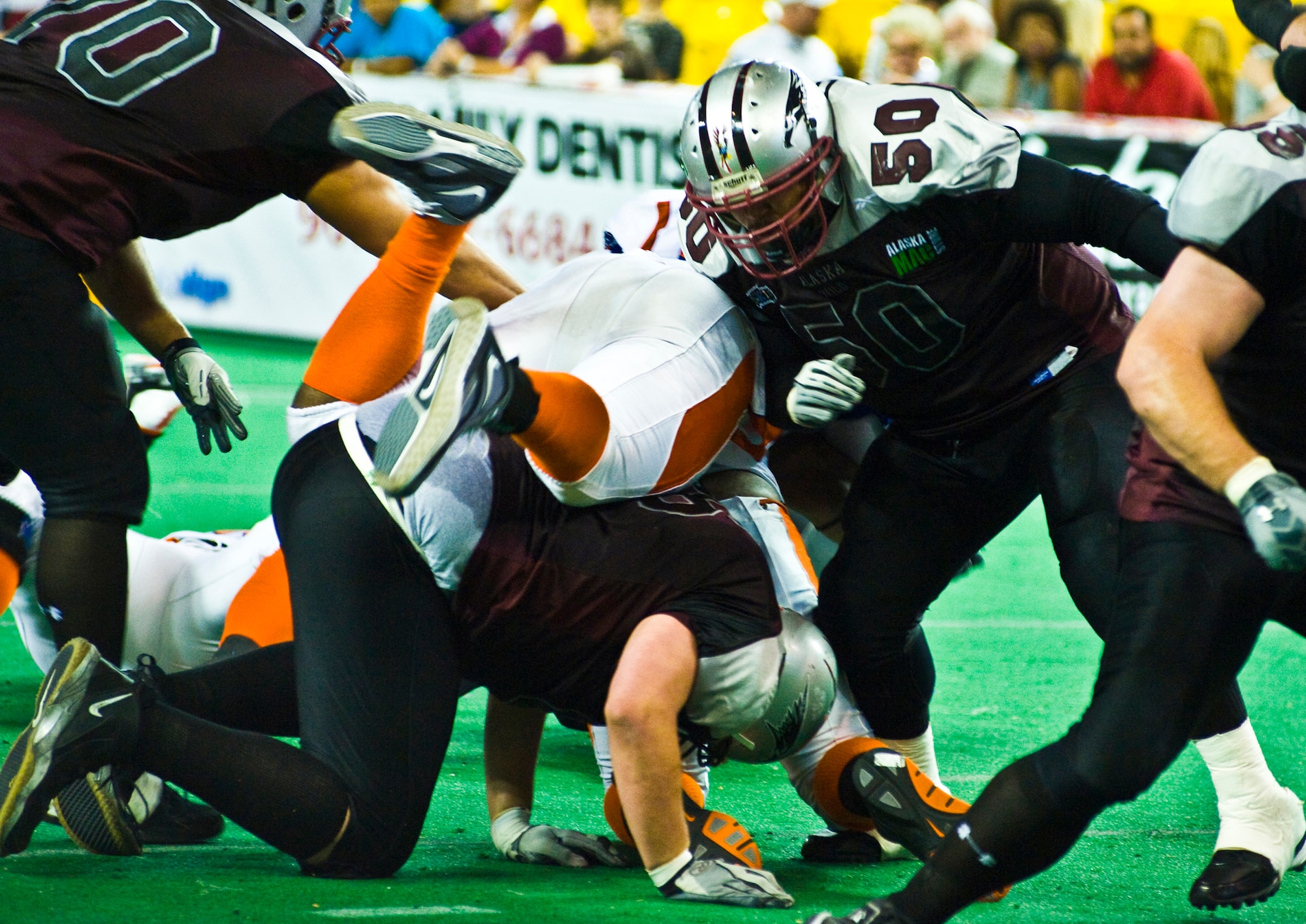 ANCHORAGE, Alaska -- Lealofi Lealofi, lineman for the Alaska Wild, throws a block into a Fairbanks Grizzlies player during season finale game July 9. The Grizzlies topped the Wild 54-25. Lealofi member of the 3rd Security Forces Squadron. (U.S. Air Force photo/Airman 1st Class Chrisotpher Gross)