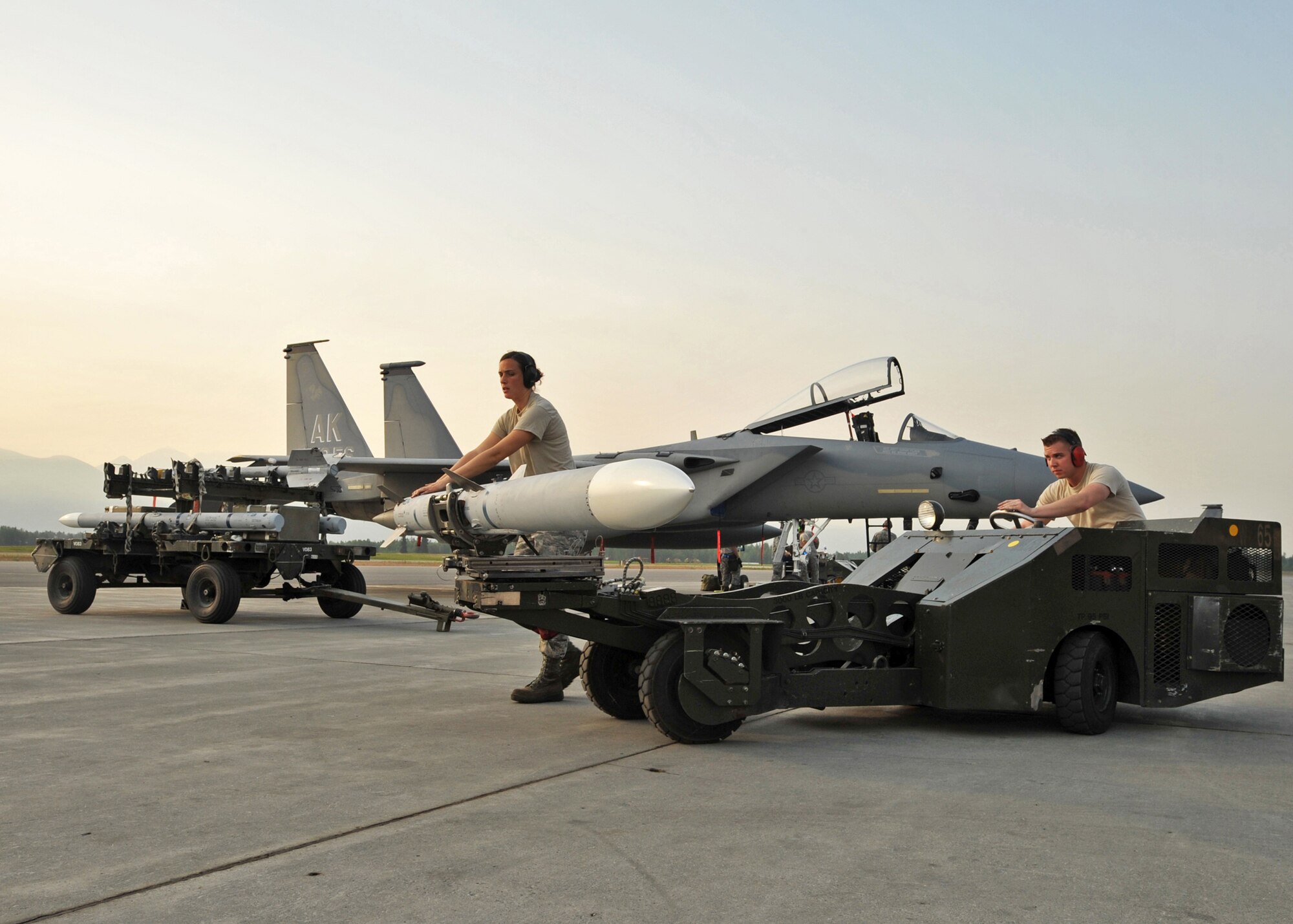 ELMENDORF AIR FORCE BASE, Alaska -- Airman 1st Class Daniel Kok and Staff Sgt. Katherine Jordan prepare to load a missile on an F-22 Raptor during a load crew competition July 10. The purpose of the competition is to demonstrate and be tested on quick turn weapon loads. Kok is a member of the 3rd Aircraft Maintenance Squadron and Jordan is a member of the 90th Aircraft Maintenance Unit. (U.S. Air Force photo/Senior Airman Laura Turner)