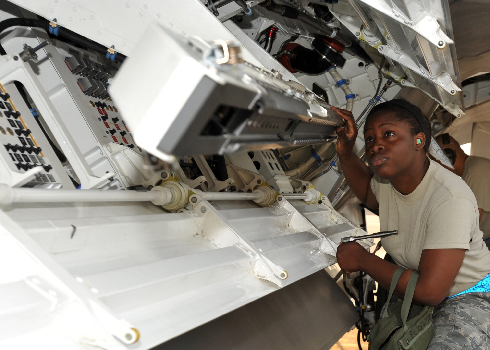 ELMENDORF AIR FORCE BASE, Alaska -- Airman 1st Class Thomasina Smalls inspects the missile bay of an F-22 during a load crew competition July 10. The purpose of the competition is to demonstrate and be tested on quick turn weapon loads. Smalls is a member of the 3rd Aircraft Maintenance Squadron. (U.S. Air Force photo/Senior Airman Laura Turner)