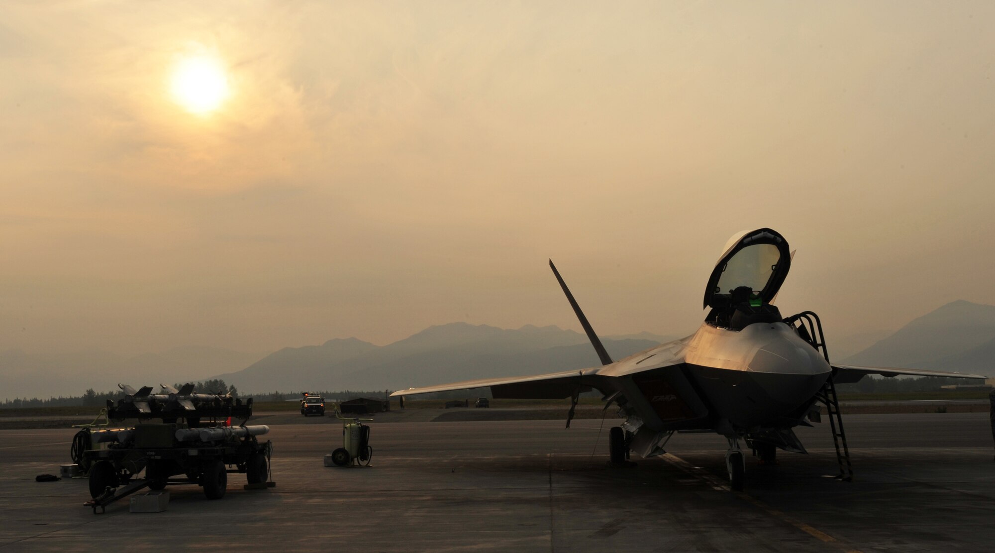 ELMENDORF AIR FORCE BASE, Alaska -- The sun beams down on an F-22 Raptor July 10 through smokey haze caused by more than 70 Alaska wildfires. A hot and dry summer has led to a wildfire outbreak across the state. (U.S. Air Force photo/Senior Airman Laura Turner)