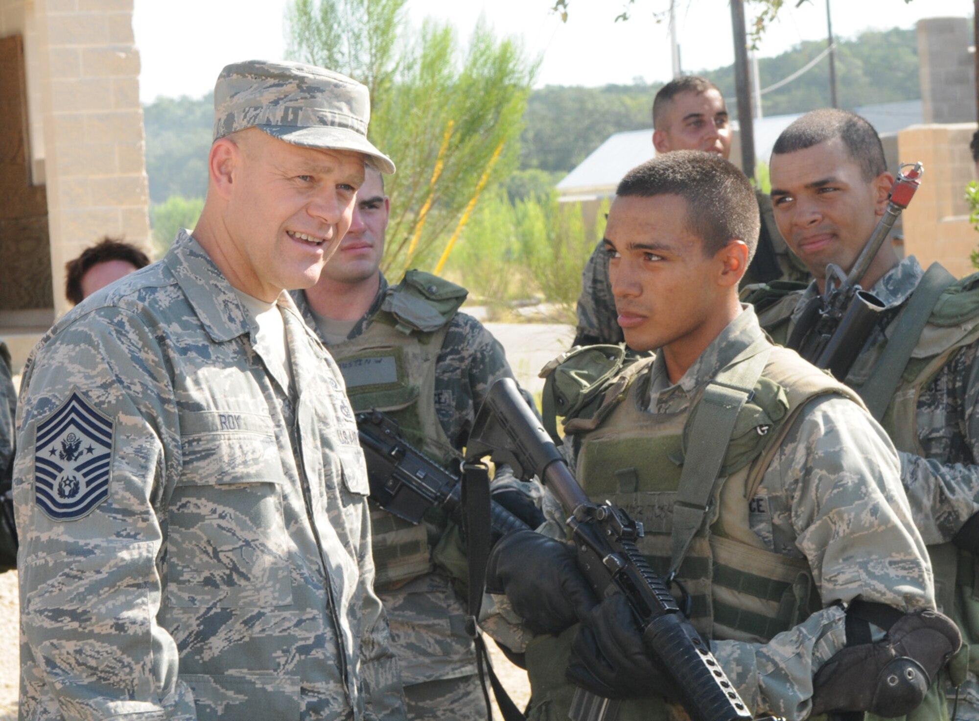 Chief Master Sergeant of the Air Force James A. Roy talks with security forces technical school students during Movement Over Urban Terrain training July 9 at Lackland Air Force Base, Texas. 