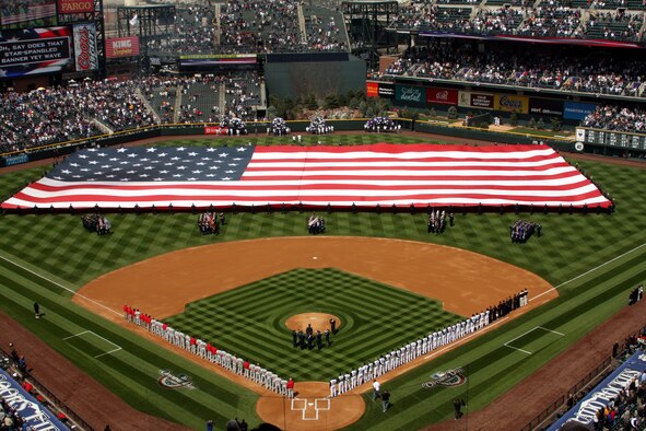 More than 200 enlisted Airmen took to the outfield at Coors Field in Denver April 10 to display the Stars and Stripes during pre-game ceremonies. Once fully unfurled, the flag was the size of a football field. (U.S. Air Force photo/Ken Carter)