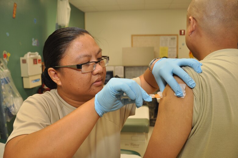 Capt. Betty Ann Buentipo, 724th Aeromedical Staging Flight nurse, administers a vaccination during the June drill weekend at the Andersen Air Force Base clinic. As a civilian, Captain Buentipo works as an emergency room nurse for Guam Memorial Hospital. The 724th ASTF is part of the 624th Regional Support Group, which is the largest Air Force Reserve presence in the Pacific. (U.S. Air Force photo/Master Sgt. Daniel Nathaniel)
