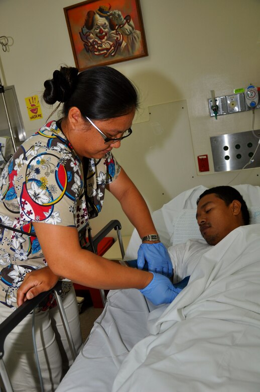 Capt. Betty Ann Buentipo, 724th Aeromedical Staging Flight nurse, treats a patient at her civilian job as an emergency room nurse at Guam Memorial Hospital. The 724th ASTF is part of the 624th Regional Support Group, which is the largest Air Force Reserve presence in the Pacific. (U.S. Air Force photo/Master Sgt. Daniel Nathaniel) 

