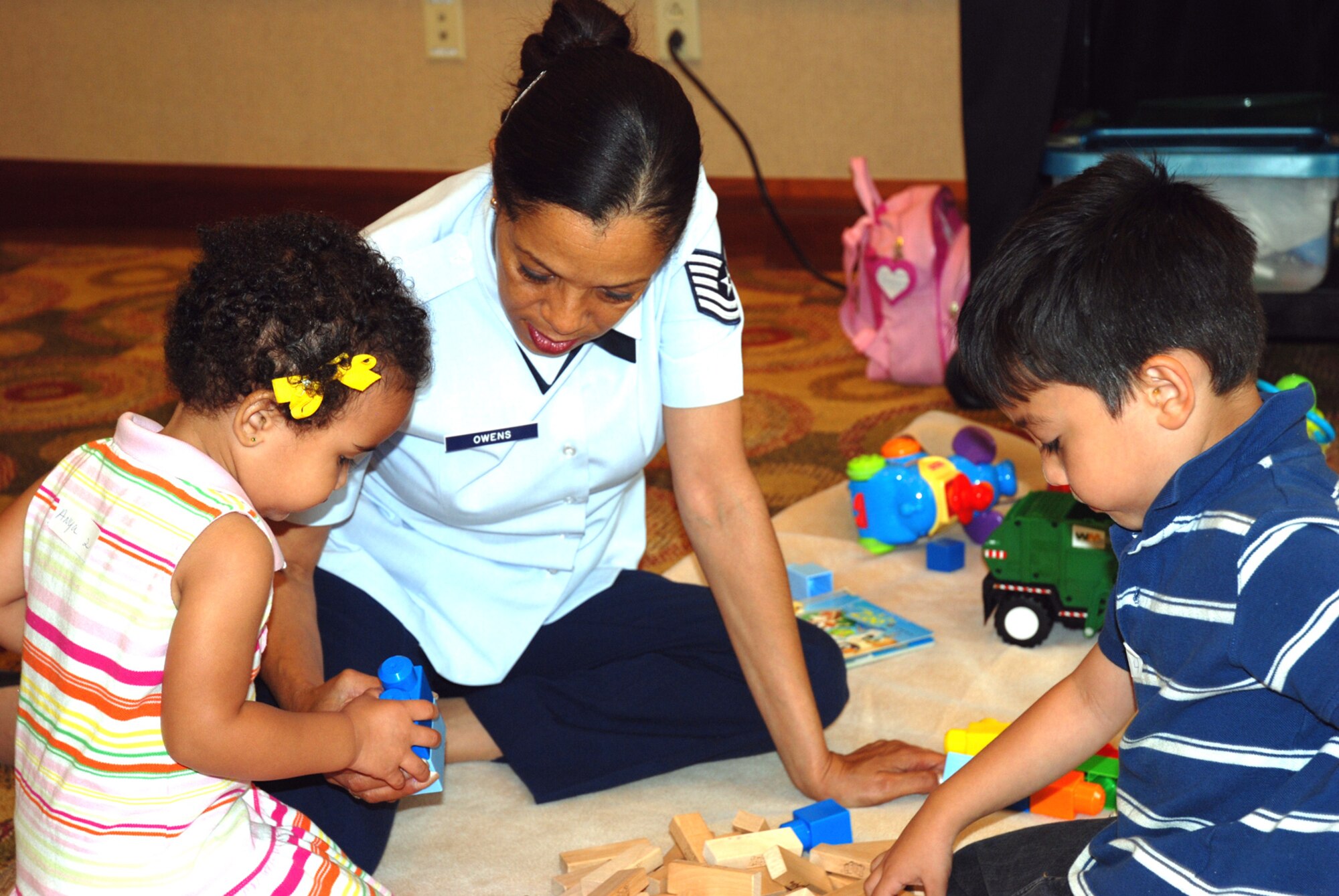 Tech.Sgt. Cynthia Owens, 94th Family Readiness Office, spends time with children of 94th Security Forces Squadron members in the "Nanny in a Pinch" room during the Yellow Ribbon event at the Chattanoogan Resort in Chattanooga, Tenn. July 11. The two-day event provided informational briefings and relaxation for recent deployers and their family members. (U.S. Air Force photos/Tech. Sgt. Bob Martin)