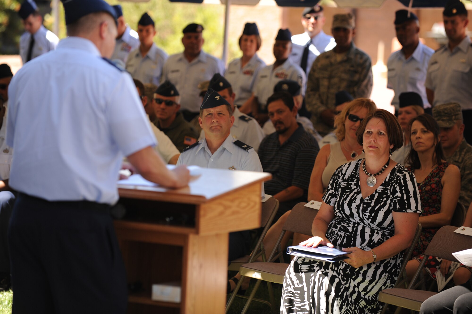 Mrs. Julia Samek, mother of Airman 1st Class Jesse Samek, does her best to hold back tears as Lt. Col. Daniel Duffy of the 66th Rescue Squadron speaks during the Samek Airmen's Center Dedication ceremony at Nellis Air Force Base on July 13, 2009. The newly renovated Airmen's Center is renamed in honor of Airman Samek. Samek was killed when his HH-60 helicopter crashed during a rescue mission in Afghanistan in 2004. Samek was the first Airman from Nellis Air Force Base to sacrifice his life in the war on terrorism following the Sept. 11, 2001 attacks.  (U.S. Air Force Photo/Tech. Sgt. Michael R. Holzworth)
