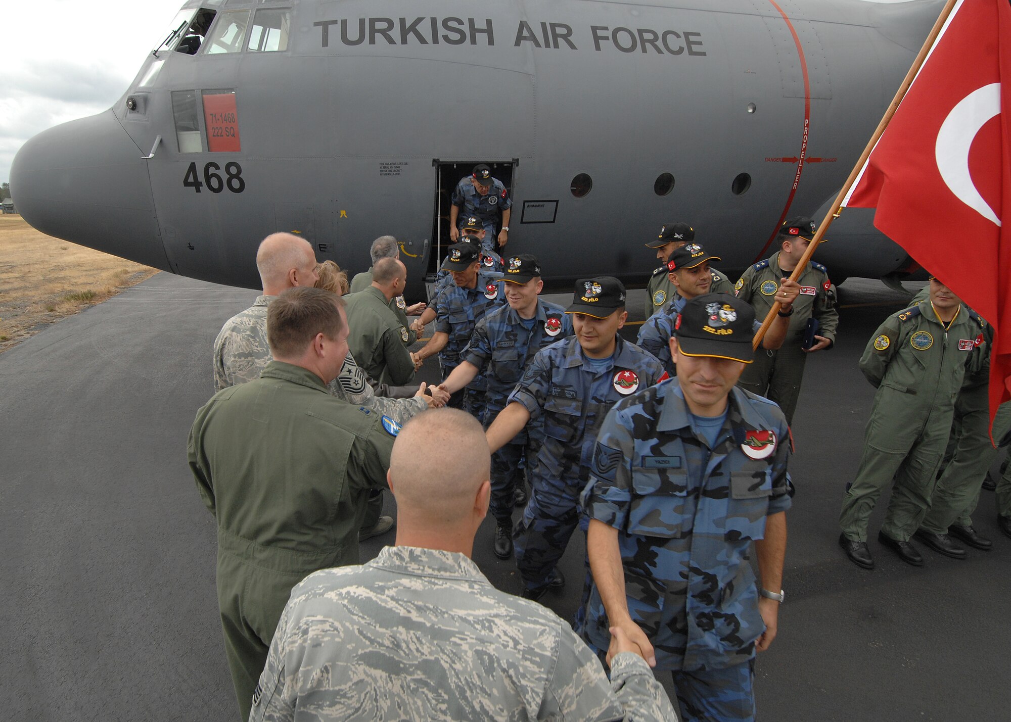 U.S. Airmen greet Turkish air force members from the 222nd C-130 Squadron, 12th Main Airlift Base, Turkey, during the international competitor arrivals for Air Mobility Command’s Rodeo 2009 at McChord July 13. Rodeo is an international combat skills and flying operations competition designed to develop and improve techniques and procedures with international partners to enhance mobility operations. (U.S. Air Force photo/Staff Sgt. Stephen Schester)