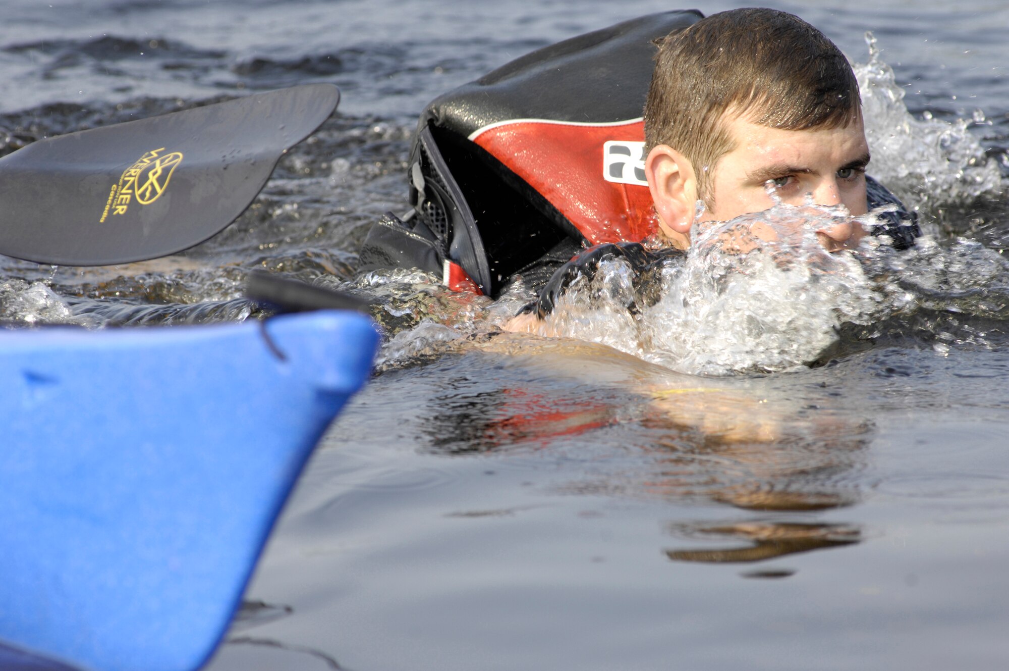 ELMENDORF AIR FORCE BASE, Alaska -- A participant races after is kayak as he tries to recover it during the 1/2-mile kayak race July 10. The kayak race was one of four events during the 5th annual Eco Challenge. The other events included running, biking and a hike with a weighted backpack. (U.S. Air Force photo/Airman 1st Class Christopher Gross)