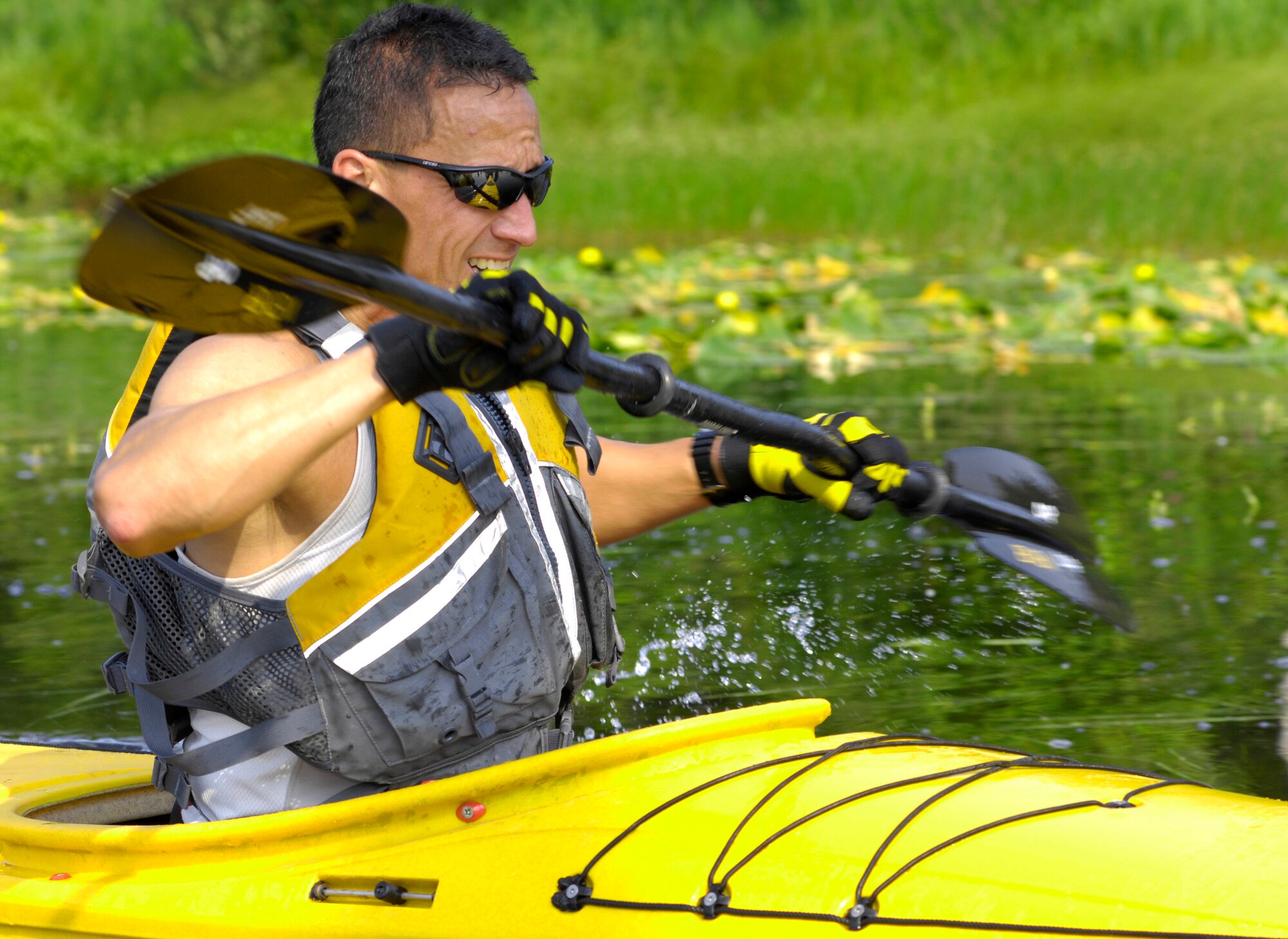 ELMENDORF AIR FORCE BASE, Alaska -- A participant finishes the last several yards of kayaking portion of the event July 10. The 1/2-mile kayak race was one of four event during the 5th annual Eco Challenge. The other events included running, biking and a hike with a weighted backpack. (U.S. Air Force photo/Airman 1st Class Christopher Gross)