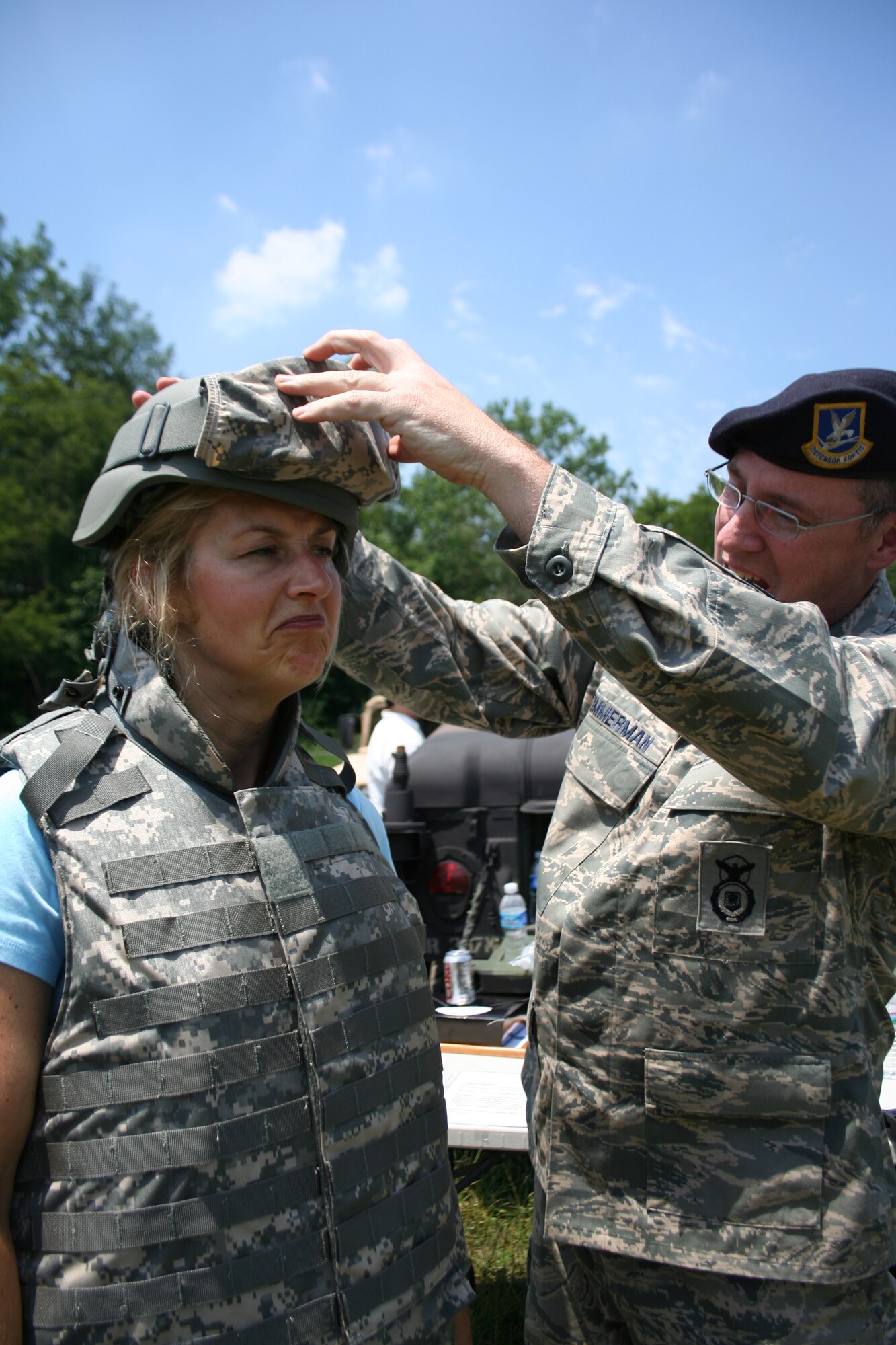 Master Sgt. Bruce Zimmerman, Security Forces Squadron,
helps gear-up Mrs. Donna White, newly inducted Honorary
Commander, at the Starvaggi Drop Zone during the recent HCA
event held June 25, 2009 (photo by Lt. Shawn Walleck.)