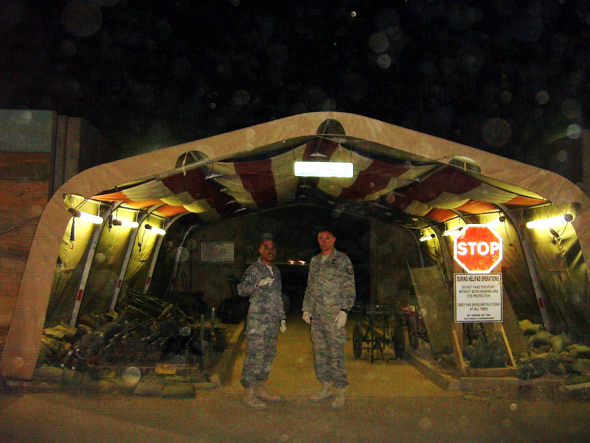 Senior Master Sgt. Mark Hatori, left, at Heroes Highway awaiting the arrival of the helicopters carrying patients. Sergeant Hatori is one of several deployed members of the 48th APS who regularly volunteers at the same hospital as Tech. Sgt. Scot
Parry (not pictured). On his first night as a volunteer, Sergeant Hatori had the fortune to experience one of the worst dust storms in years. (Courtesy photo)
