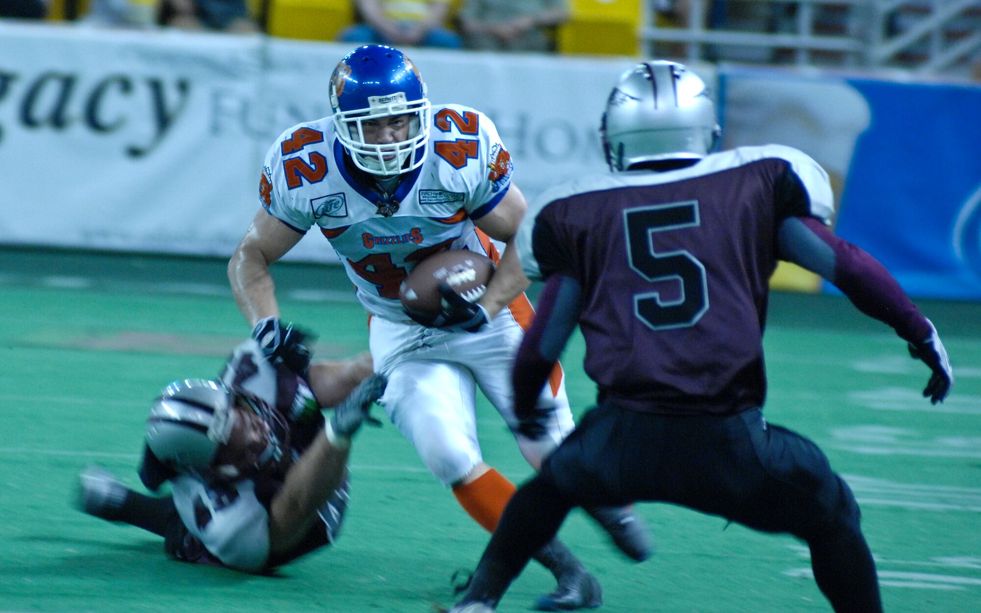 ANCHORAGE, Alaska -- Alaska Wild football player Joe Small prepares to tackle Fairbanks Grizzlies runner Michael Quinn during the first half of the Alaska Wild's season finale game against the Fairbanks Grizzlies July 9. Three active-duty Airmen from Elmendorf Air Force Base, Alaska, play for the Alaska Wild team. (U.S. Air Force photo/Senior Airman David Carbajal)