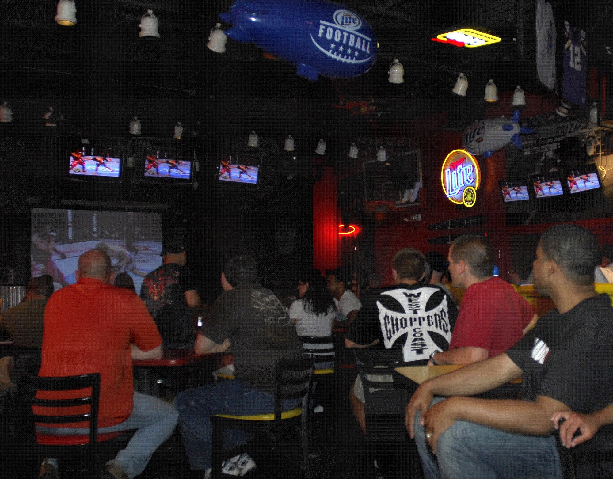 MINOT AIR FORCE BASE, N.D. – A group of fight fans watch the action of the Ultimate Fighting Championship which aired at J.R. Rockers here Jul 11. The mixed martial art sport is normally a pay-per-view event. However, thanks to Air Combat Command sponsorship, the event was free to club members. (U.S. Air Force photo by Airman 1st Class Jesse Lopez)