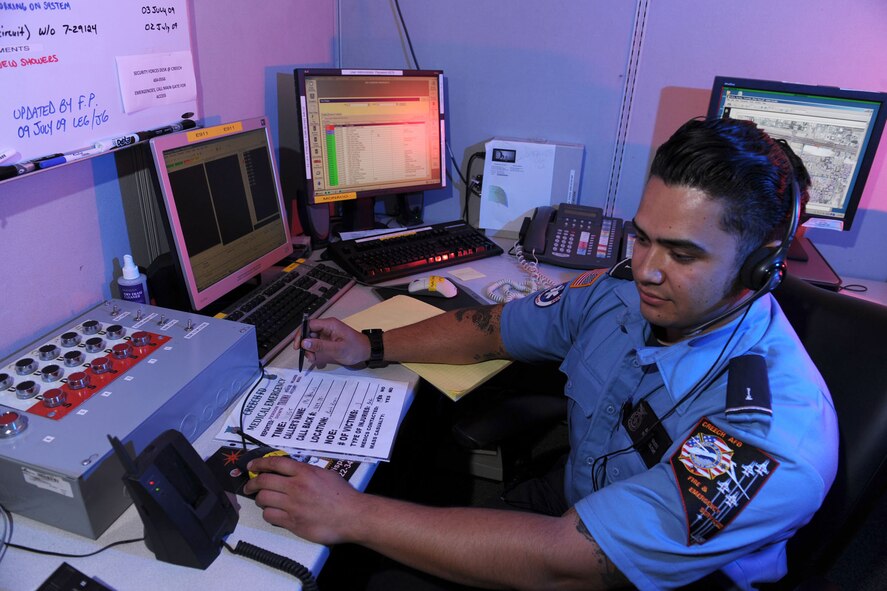 Mr. Cody Woolett, Creech firefighter/emergency medical technician, monitors alarms and stands by ready to dispatch fire and medical crews.  (U.S. Air Force Photo/Mr. Lawrence Crespo)