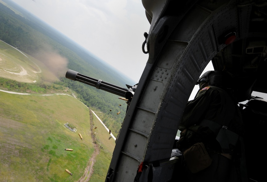 MOODY AIR FORCE BASE, Ga. -- Senior Master Sgt. Michael Stone, 41st Rescue Squadron aerial gunner, fires a GAU-2/A 7.62mm minigun during training.  Aerial gunners recently became their own career field in October 2001. (U.S. Air Force photo by Senior Airman Gina Chiaverotti)