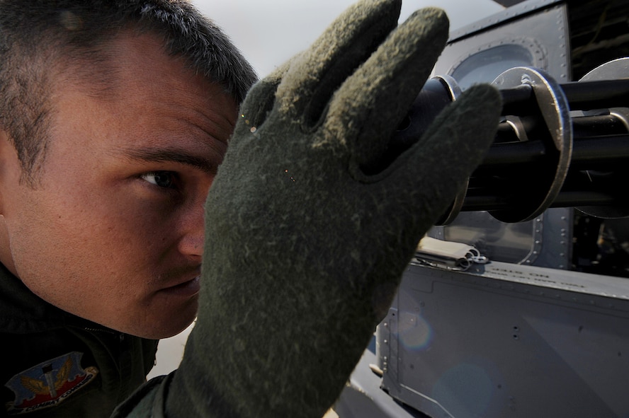 MOODY AIR FORCE BASE, Ga. -- Airman 1st Class Michael Boehmer, 41st Rescue Squadron aerial gunner, inspects a GAU-2/A 7.62mm minigun. Aerial gunners inspect their weapons prior to any flight. (U.S. Air Force photo by Senior Airman Gina Chiaverotti)
