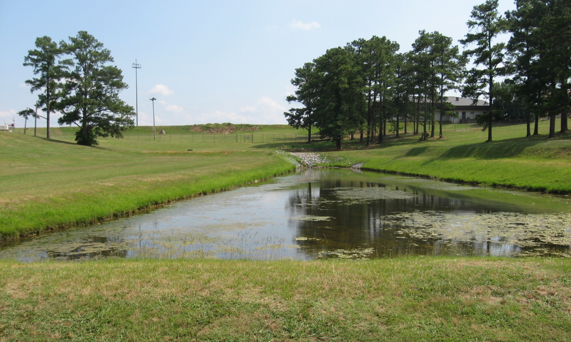 Base civil engineers are working to fix ponds such as the the one pictured here, Spill Pond 4, to prevent oil spills from the flight line from polluting the environment. 