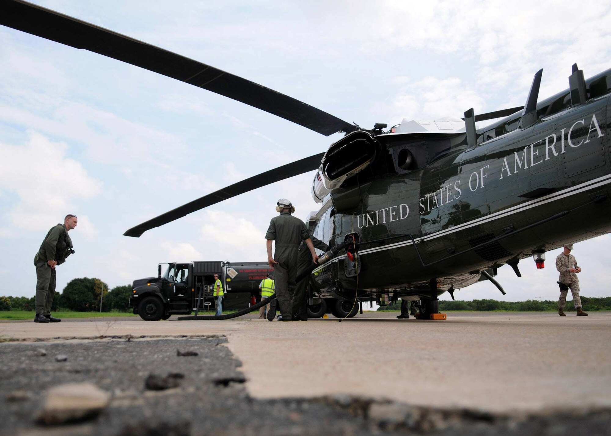 Members of the 435th Logistics Readiness Squadron assist with refueling Marine One at Kotoka International Airport July 6 at Accra, Ghana. The Airmen are among more than 150 Airmen, Sailors and Marines in Ghana and Sailors aboard the USS Iwo Jima who came together to form a task force to support President Obama's visit July 10 and 11. Members of the 435 LRS are a petroleum, oils and lubricants team from Ramstein Air Base, Germany. (U.S. Air Force photo/Staff Sgt. Jerry Fleshman) 