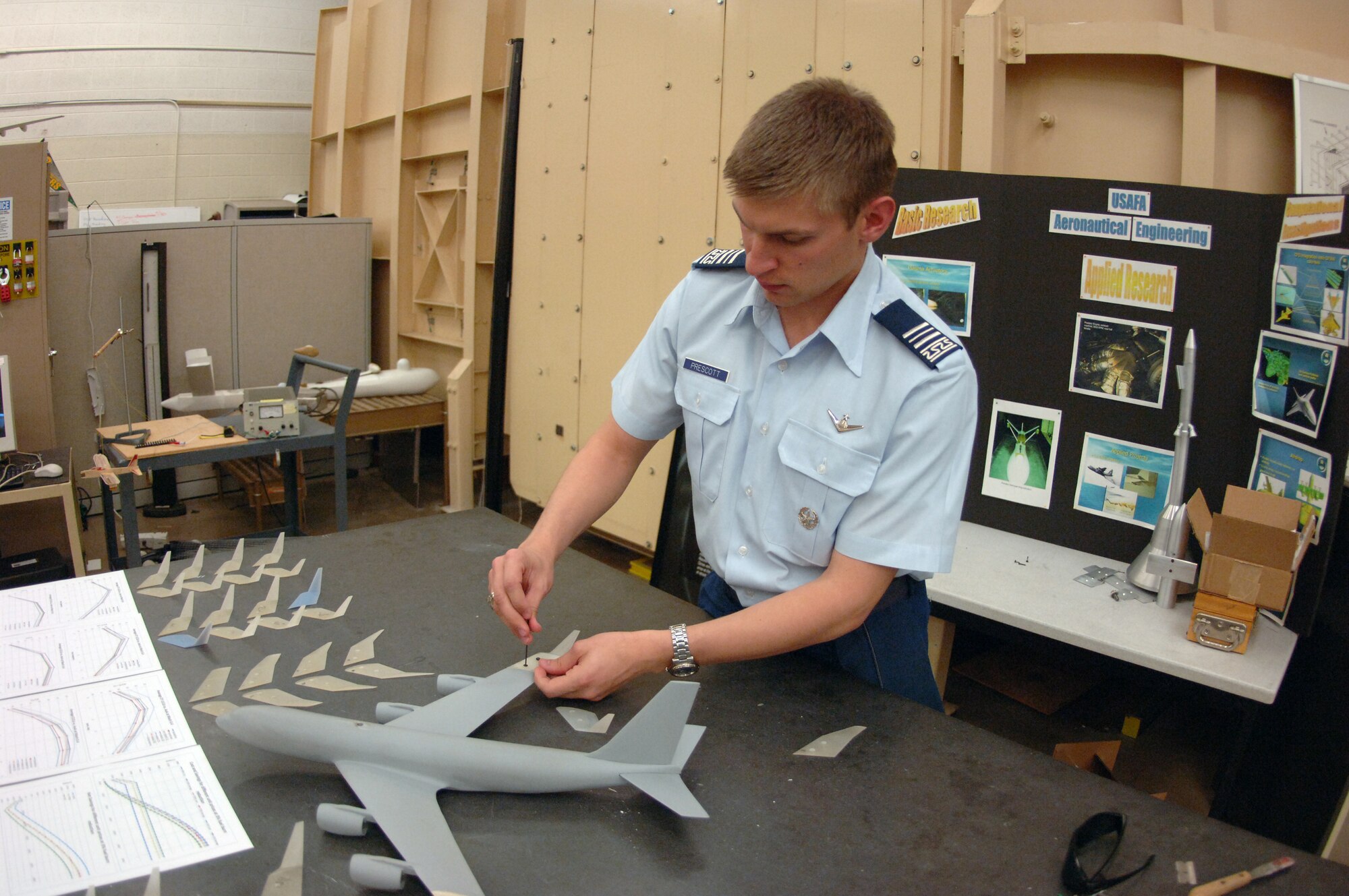 Cadet 1st Class Daniel Prescott affixes winglets to a model of a KC-135 Stratotanker in an aeronautical engineering lab at the U.S. Air Force Academy, Colo., Nov. 3, 2008. The department's research predicts an 8-percent improvement in fuel efficiency from the winglets, which reduce the effects of drag on the aircraft. (U.S. Air Force photo/John Van Winkle)