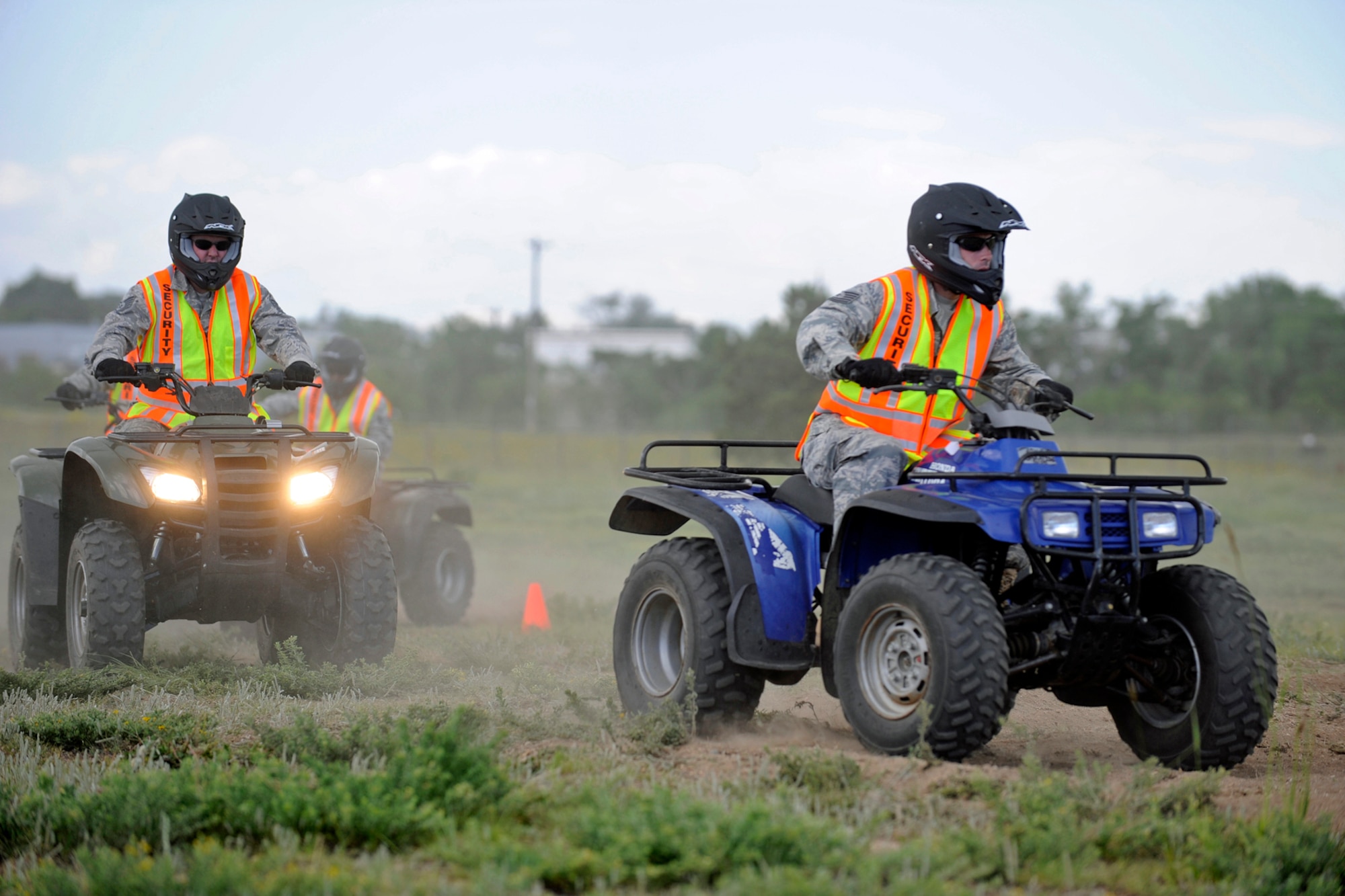 PETERSON AIR FORCE BASE, Colo. -- Tech. Sgt. David Berry, 721st Security Forces Squadron (right), and five other 721st SFS Airmen participated in all-terrain vehicle training June 6 at Peterson. According to Tech. Sgt. Sean Gallagher, 721st SFS unit deployment monitor, the training is designed to enhance Cheyenne Mountain security force response capabilities and broaden the skills of deploying security forces Airmen. (Air Force photo by Craig Denton) 