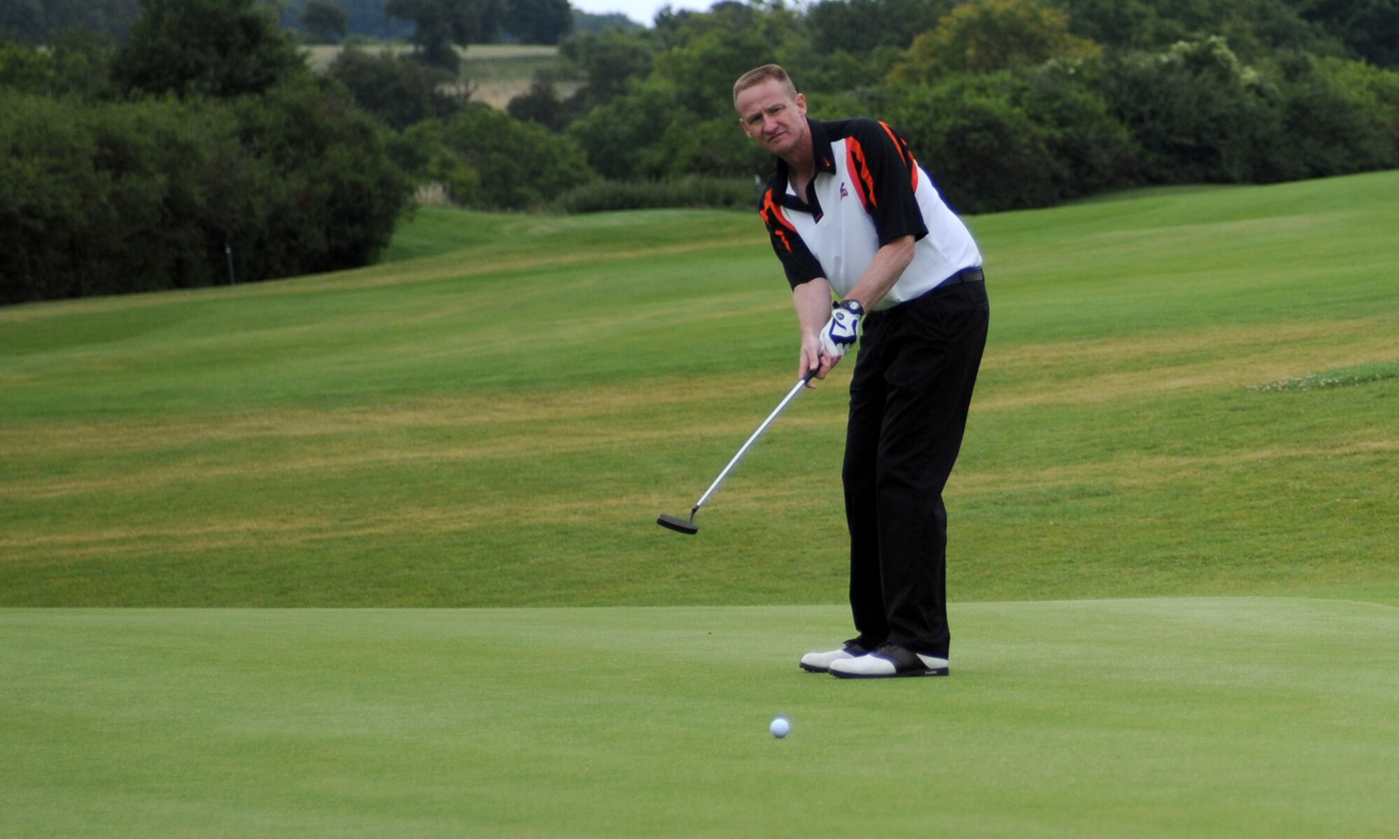 SPANGDAHLEM AIR BASE, Germany -- Chief Master Sgt. Scott Wilson, 52nd Mission Support Group superintendent, focuses on a putt during the Fourth Eifel Friendship Cup 2009 tournament July 11. Members of the 52nd Fighter Wing spent the day socializing with members of the Host Nation Council. Tournament teams consisted of three 52nd FW members and a German. (U.S. Air Force photo by Airman 1st Class Nathanael Callon)