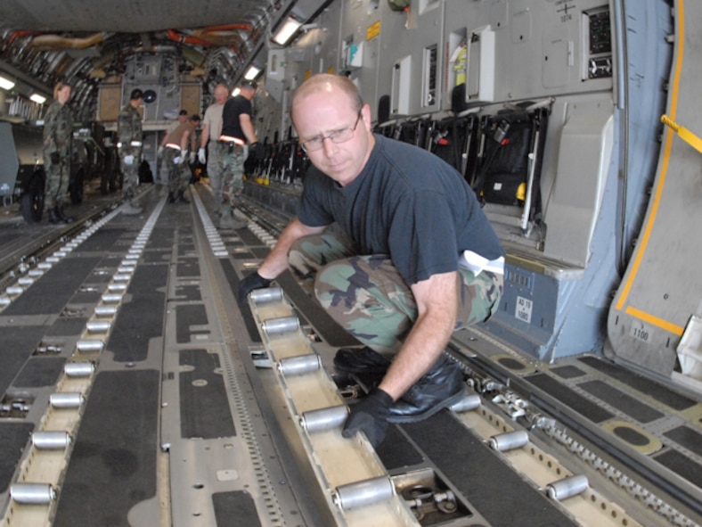 Master Sgt. Todd Strom, of the 119th Logistics Readiness Squadron, prepares an Alaska Air National Guard 249th Airlift Wing C-17 for loading July 8, at the North Dakota Air National Guard, as he begins loading equipment (also known as increments) for air lift to Volk Field, Wisc.   The airman is a member of the newly created 119th Air Terminal Flight (also known as Aerial Port).  The increments being loaded are part of the first ever shipment known as a 'chalk' for the Aerial Port at the NDANG.    (DoD photo by Senior Master Sgt. David H. Lipp) (Released)
