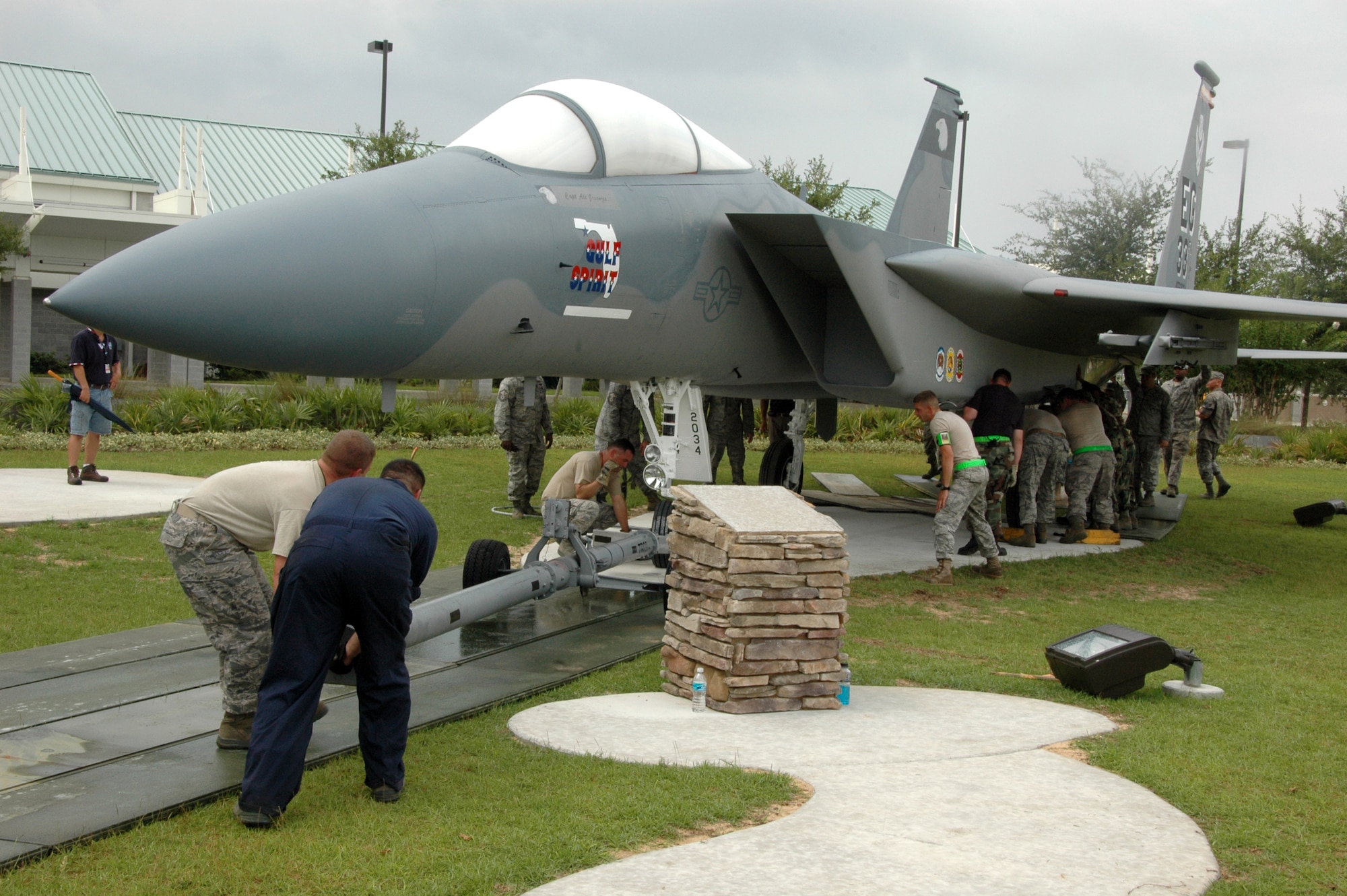 Members of the 33rd Maintenance Squadron place an F-15A at its new home in front of the Northwest Florida Regional Airport July 13 after towing it across the shared flightline on Eglin Air Force Base, Fla. Since 1978, 33rd Fighter Wing F-15s have flown over Eglin and the local community.  The last one will exit in September, just before the wing transitions to an F-35 Joint Strike Fighter training unit under Air Education and Training Command Oct. 1. (U.S. Air Force photo/Staff Sgt. Bryan Franks.)