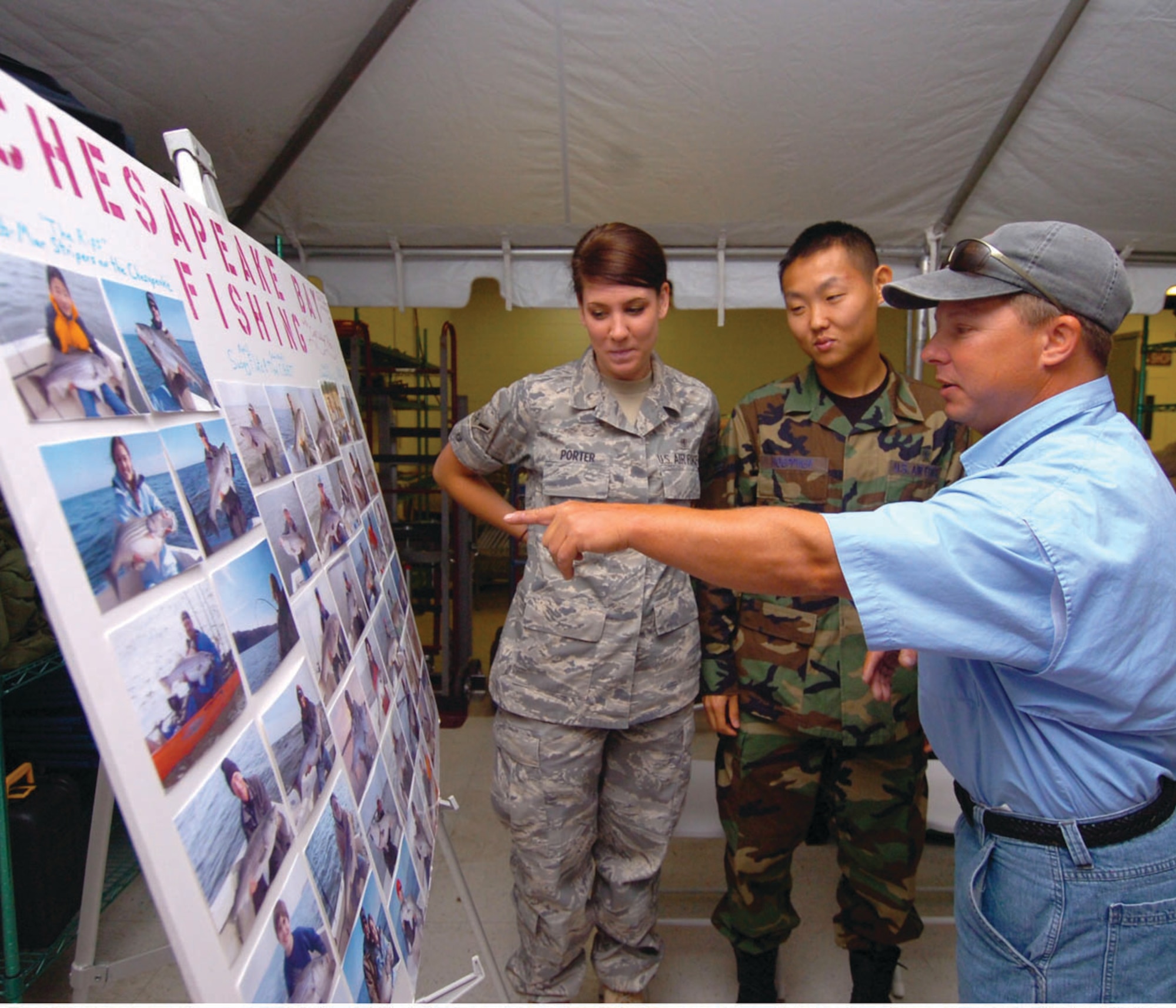 Captain “Walleye” Pete Dalhberg, a professional fisherman, talks with Airman Olivia Porter and Airman 1st Class Nelson Hoeppner, 779th Medical Support Squadron medical technicians, about chartered fishing trips in the Chesapeake Bay area. Mr. Dalhberg was the featured guest at the Outdoor Recreation Open House to inform Airmen about the various services supported by the 316th Force Support Squadron. During the open house, raffle tickets for prizes were given to visitors as well as free food and refreshments. Events featured at the open house included an upcoming ski trip, New York trip and chartered Chesapeake Bay fishing trip. (U.S. Air Force photo/ Bobby Jones)