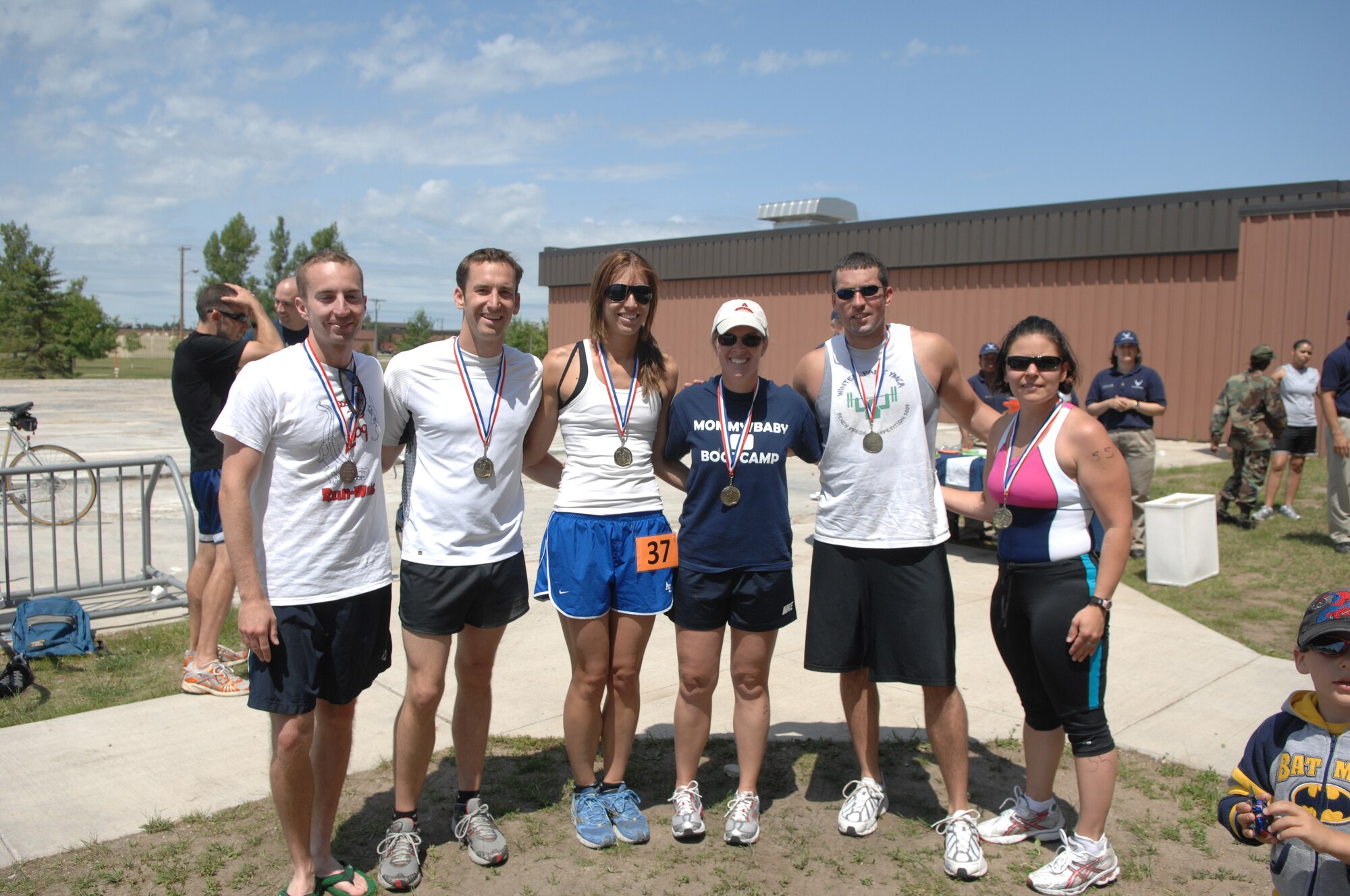 MINOT AIR FORCE BASE, N.D.-- Men and women who received award medals for winning first , second, and third places in the here July 11. Men and women, civilian and military from across the base participated in the triathlon. The triathlon consists of an one-half mile swim, ten kilometer bicycling, and a five kilometer run.  The 5th Force Support Squadron organized the event to promote physical fitness and team building. (U.S. Air Force photo by Staff Sgt. Angel Gallardo)