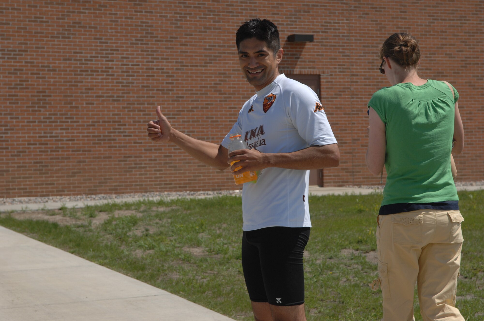 MINOT AIR FORCE BASE, N.D. – Capt. Doug Rodriguez from the 23th Bomb Squadron gives the thumbs up after he completed the triathlon here July 11. Men and women, civilian and military from across the base participated in the triathlon. The triathlon consists of an one-half mile swim, ten kilometer bicycling, and a five kilometer run.  The 5th Force Support Squadron organized the event to promote physical fitness and team building. (U.S. Air Force photo by Staff Sgt. Angel Gallardo)
