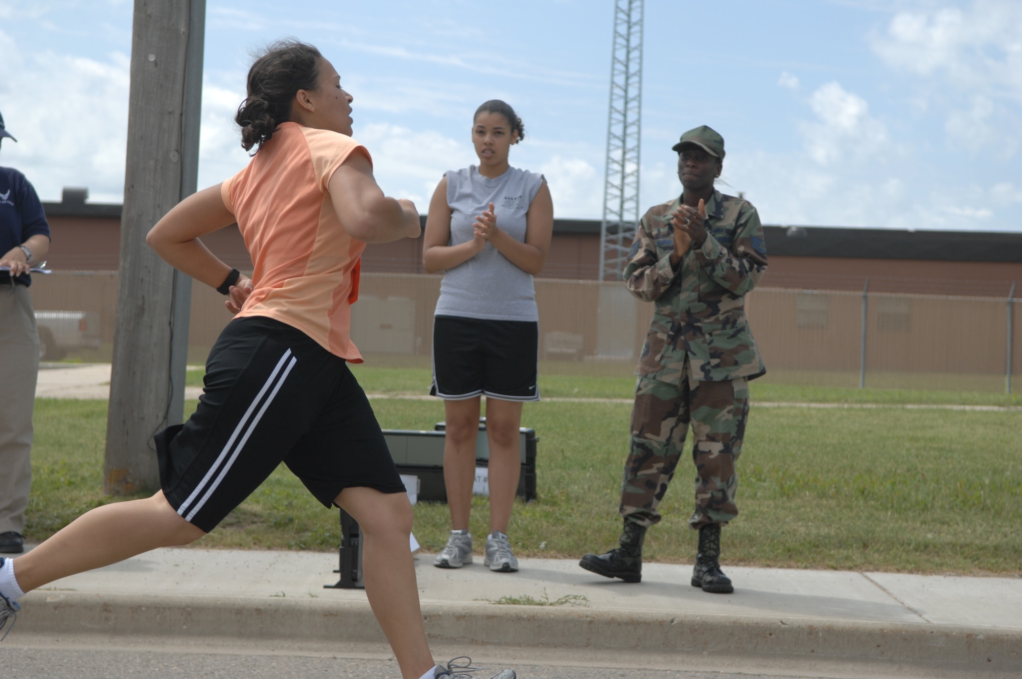 MINOT AIR FORCE BASE, N.D.-- Shauna Ward crosses the finish line during a triathlon here July 11. Men and women, civilian and military from across the base participated the triathlon, which consisted of an one-half mile swim, ten kilometer bicycling, and a five kilometer run.  The 5th Force Support Squadron organized the event to promote physical fitness and team building. (U.S. Air Force photo by Staff Sgt. Angel Gallardo)