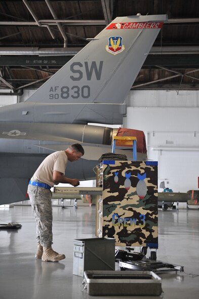 SHAW AFB, S.C. -- Airman 1st Class Sean Tyree, 55th Aircraft Maintenance Unit load crew member, returns his tools at the end of the quarterly load competition, July 8. The 20th Aircraft Maintenance Squadron holds load crew competitions not only to allow their AMUs to compete for bragging rights but to also showcase their job expertise. (U.S. Air Force photo/Senior Airman Kathrine McDowell)

