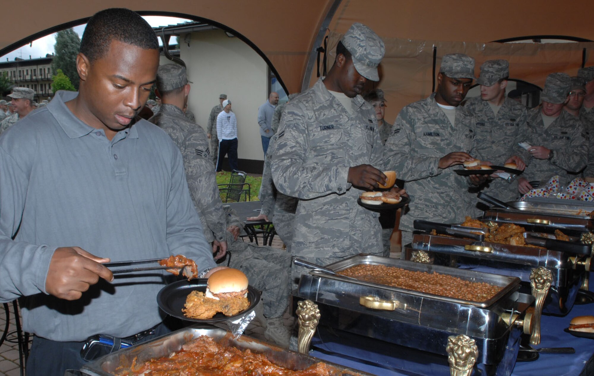 SPANGDAHLEM AIR BASE, Germany— Members of the 52nd Fighter Wing enjoy the food prepared at the post Unit Compliance and Logistical Standardization and Evaluation Program inspections celebration July 10. Col. Tip Wight, 52nd Fighter Wing commander, rewarded Sabers with a party which included a barbeque and various activities for Airmen. (U.S. Air Force photo by Airman 1st Class Nick Wilson)