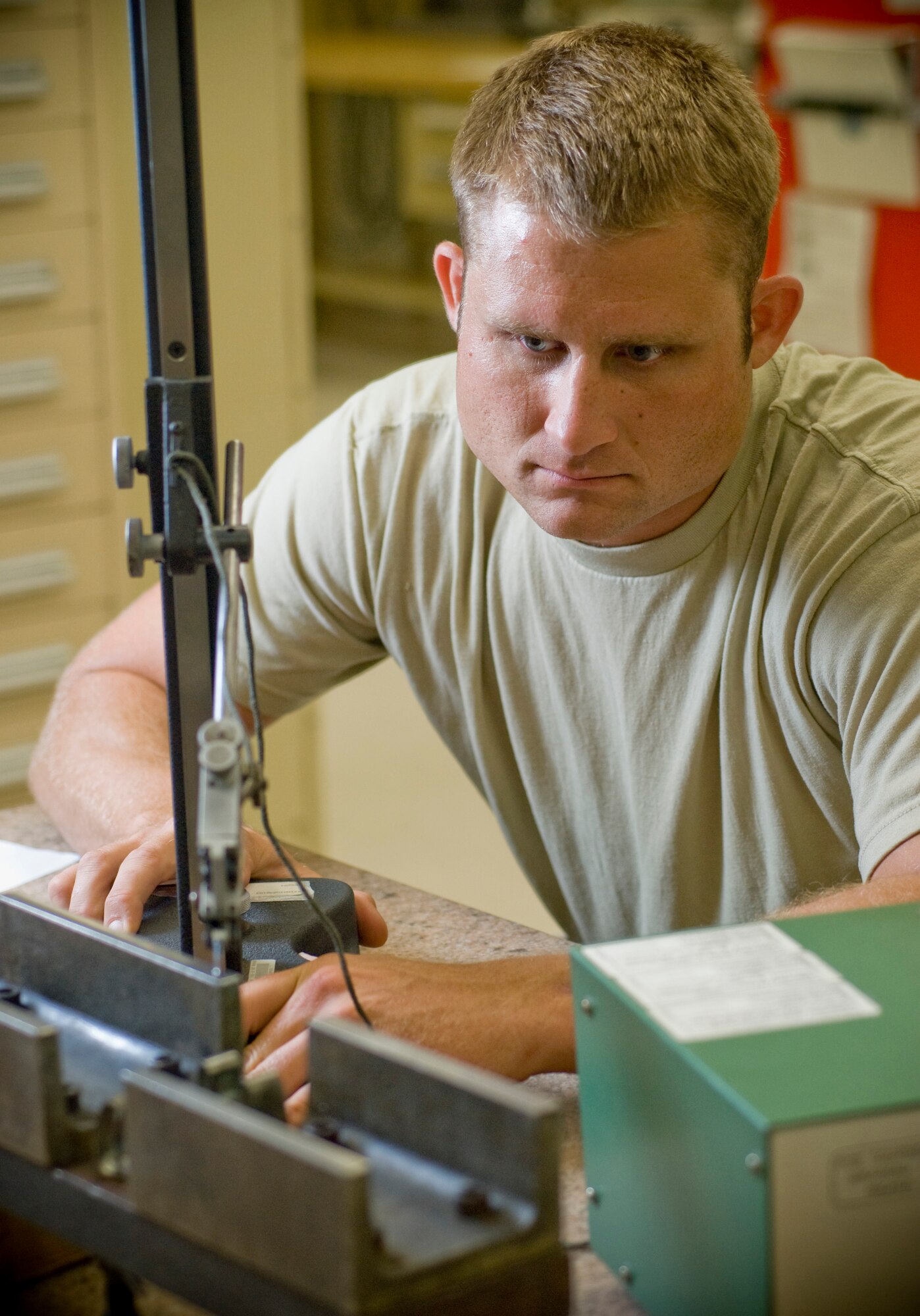 Staff Sgt. Frederick Keese, 8th Maintenance Squadron, calibrates a drag brace fixture with an electronic height gauge at Kunsan Air Base. Republic of Korea July 14. Sergeant Keese is a precision measurement equipment laboratory craftsman for the test measurement and diagnostic equipment flight. The TMDE flight is responsible for keeping equipment intolerance and on target. (U.S. Air Force photo by Senior Airman Jonathan Steffen)