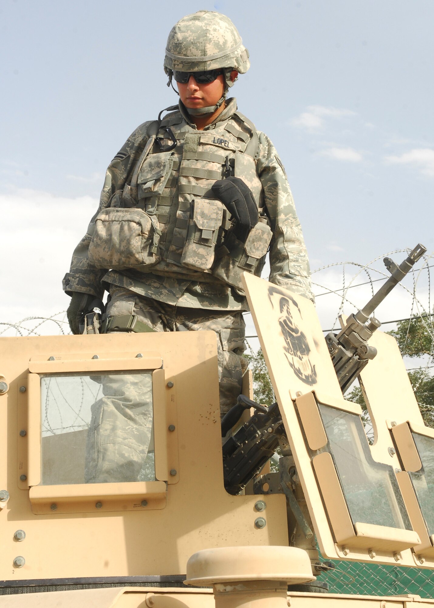 Airman 1st Class Diana Lopez deployed from Edwards Air Force Base, Calif., is a warrior. She calmly and confidently mans her M-249 Automatic Rifle, mounted on her vehicle, nicknamed "The Royal Flush," despite the potential threat all around her. (U.S. Air Force photo/Senior Airman Susan Tracy)