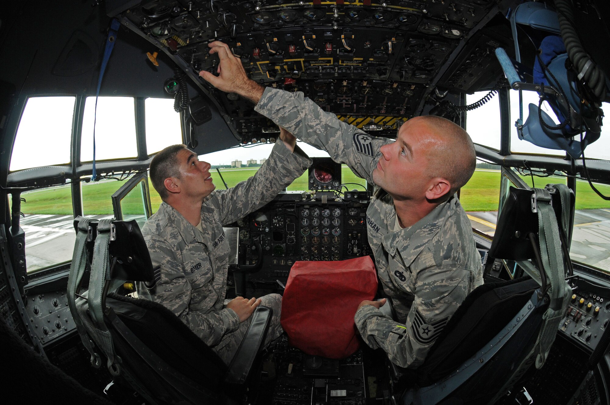 YOKOTA AIR BASE, Japan -- Staff Sgt. Corey Boyer, 374th Aircraft Maintenance Squadron communications navigation system lead technician, (left) and Tech. Sgt. Christopher Vaughn, 374th AMXS instrument flight control systems lead technician, perform a functional check on avionics equipment inside the cockpit of a C-130 Hercules. The 374th AMXS has been preparing a C-130 for the 2009 Air Mobility Command Rodeo, which begins July 19 at McChord Air Force Base, Wash. Sergeants Vaughn and Boyer are part of the maintenance team from Yokota that will compete. (U.S. Air Force photo/Staff Sgt. Veronica Pierce)