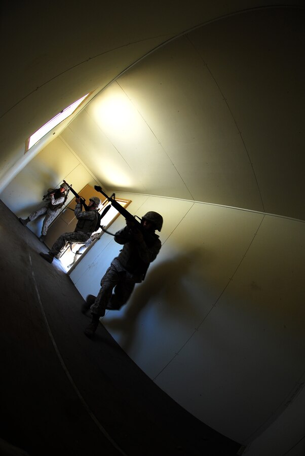 Yuma Headquarters and Headquarters Squadron Marines clear rooms during the Enhanced Combat Skills course in Camp Pendleton, Calif., July 14, 2009. The course was conducted by 1st Marine Logistics Group and taught by infantrymen with combat experience.