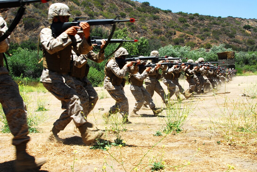 Yuma Headquarters and Headquarters squadron Marines practice the “combat gliding” technique July 13, 2009, during the Enhanced Combat Skills course held by the 1st Marine Logistics Group at Camp Pendleton, Calif. The combat glide enables Marines to keep a low profile and move with speed and agility. The squadron participated in the course from July 12-17, 2009.