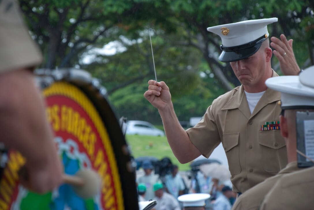 HONOLULU - Staff Sgt. Stephen Davis leads the U.S. Marine Forces Pacific Ceremonial Band during  a visit by Japanese Emperor Akihito and Empress Michiko at the National Memorial Cemetery of the Pacific (Punchbowl) July 15. During their stay, the imperial couple paid tribute to fallen service members with a wreath laying ceremony. Their July 14 arrival marks their first visit in more than 50 years.  Davis is the MarForPac Band's enlisted conductor.  (Official U.S. Marine Corps Photo by Sgt. Juan D. Alfonso)