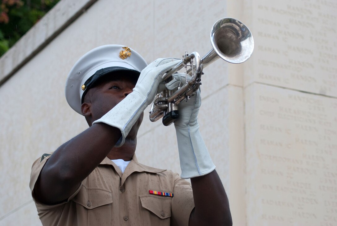 HONOLULU - Cpl. Marcus Smith plays taps at the National Memorial Cemetery of the Pacific (Punchbowl) July 15, during a wreath laying ceremony and visit by Japanese Emperor Akihito and Empress Michiko. During their stay, the imperial couple paid tribute to fallen service members with a wreath laying ceremony. Their July 14 arrival marks their first visit in more than 50 years.  Smith is a musician with the U.S. Marine Forces, Pacific Band. (Official U.S. Marine Corps Photo by Sgt. Juan D. Alfonso)