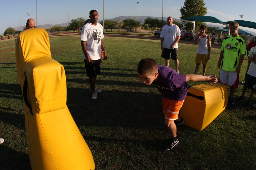 MARINE CORPS AIR GROUND COMBAT CENTER TWENTYNINE PALMS, Calif. – Chris Hayes, former safety for the Green Bay Packers and Super Bowl XXXI champion, mentored children ages 7 through 18 for three days at Felix Field July 15, in a football program called Coaches Solution Innovations.::r::::n::