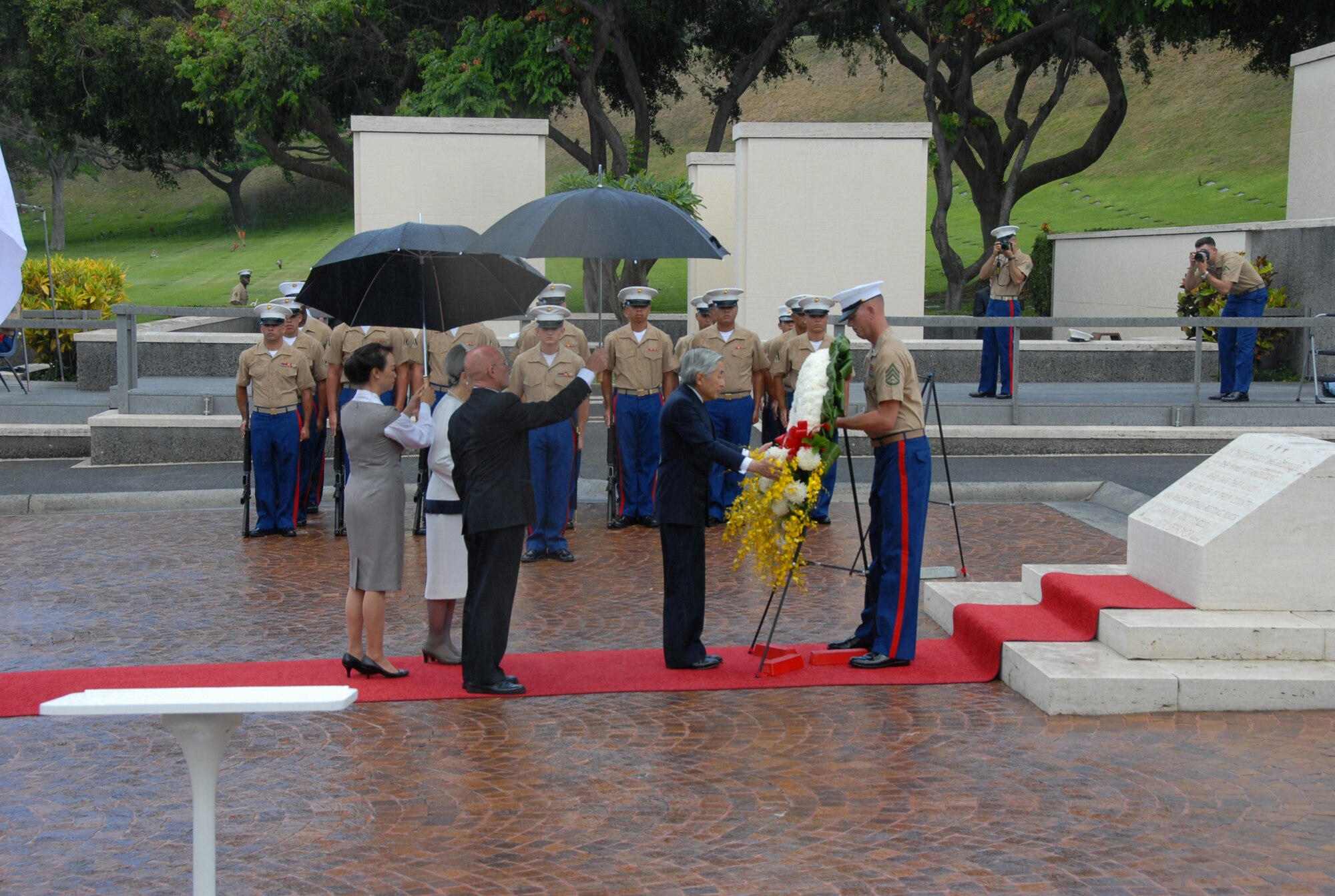 Emperor Akihito, Emperor of Japan, lays a chrysanthemum wreath at the National Memorial Cemetery of the Pacific at Punchbowl Crater, Hawaii, July 15. Emperor Akihito and Empress Michiko paid tribute to those interred at the cemetery in a ceremony attended by Hawaii Gov. Linda Lingle, Navy Adm. Timothy Keating, U.S. Pacific Command commander and Pacific Air Forces commander, Gen. Howie Chandler. The ceremony also included a 21-gun salute, a joint flyover by U.S. Navy and Japan Self Defense Forces aircraft and the playing of "Taps." More than 50,000 service men and women are interred at the cemetery, roughly 13,000 who died in World War II. (U.S. Air Force photo/Staff Sgt. LuCelia Ball)