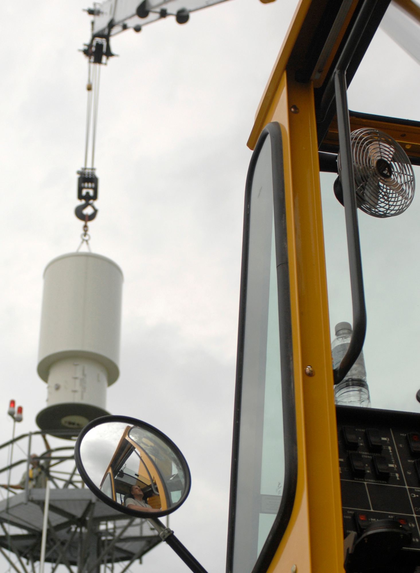 WHITEMAN AIR FORCE BASE, Mo. - Tech. Sgt. Jesse Perkins, 509th Maintenance Squadron, uses a crane July 13 to remove an old tactical navigation antenna to prepare for installation of a newer, and larger, model. The $1.5 million project is scheduled to be completed July 21. 
The new antenna will provide increased up-time allowing launch and recovery of aircraft day or night in any kind of weather, said 1st Lt. Donald Roley, 509th Operations Support Squadron. (U.S. Air force photo/Staff Sgt. Jason Barebo)
