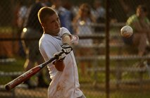 Tyson Mettler of the 1st Combat Camera Squadron keeps his eyes on the ball as he swings for the fences during a game against the 437th Aerial Port Squadron July 14. Mettler is a maintainer in the 1 CTCS. (U.S. Air Force photo/ Senior Airman Nicholas Pilch)
